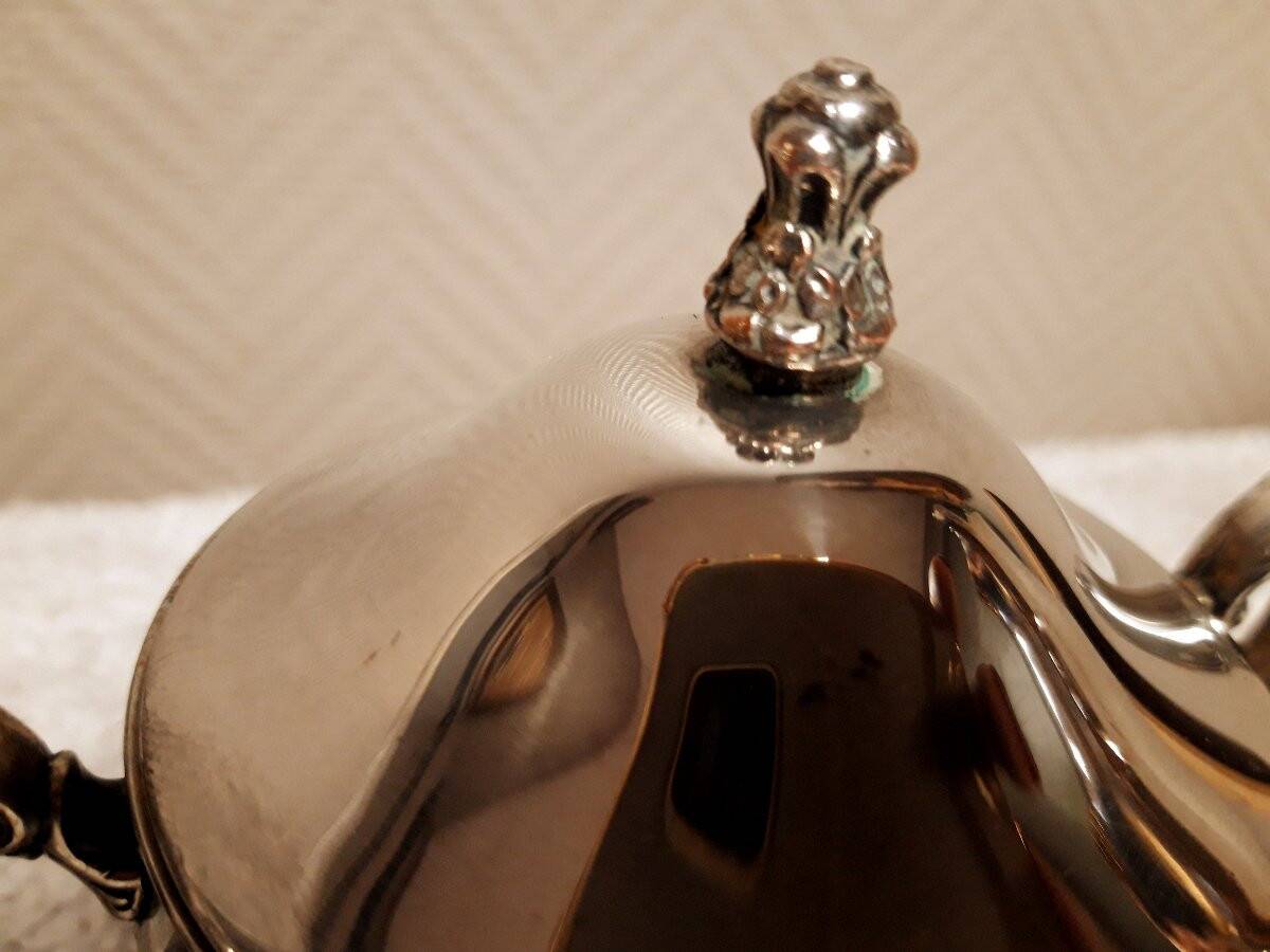 Silver-plated coffee and tea service including a coffee pot, a teapot, and a sugar bowl.