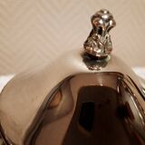 Silver-plated coffee and tea service including a coffee pot, a teapot, and a sugar bowl.