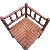 Old corner straw armchair in turned wood