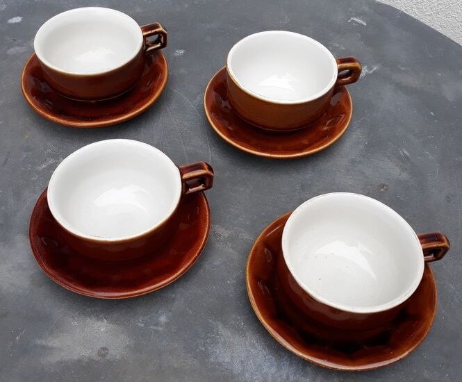 Old cups and under cups of coffee - brown ceramics typical of station buffets