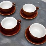Old cups and under cups of coffee - brown ceramics typical of station buffets