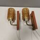 A set of wall lamps in teak wood, with amber colored glass