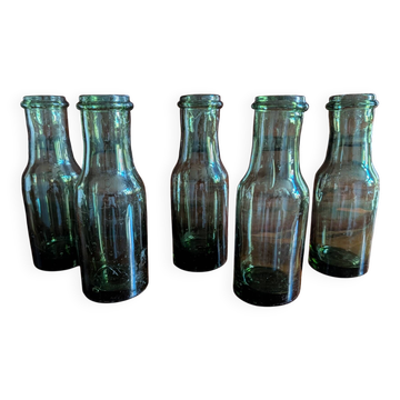 Set of 5 antique bottles in olive green glass.