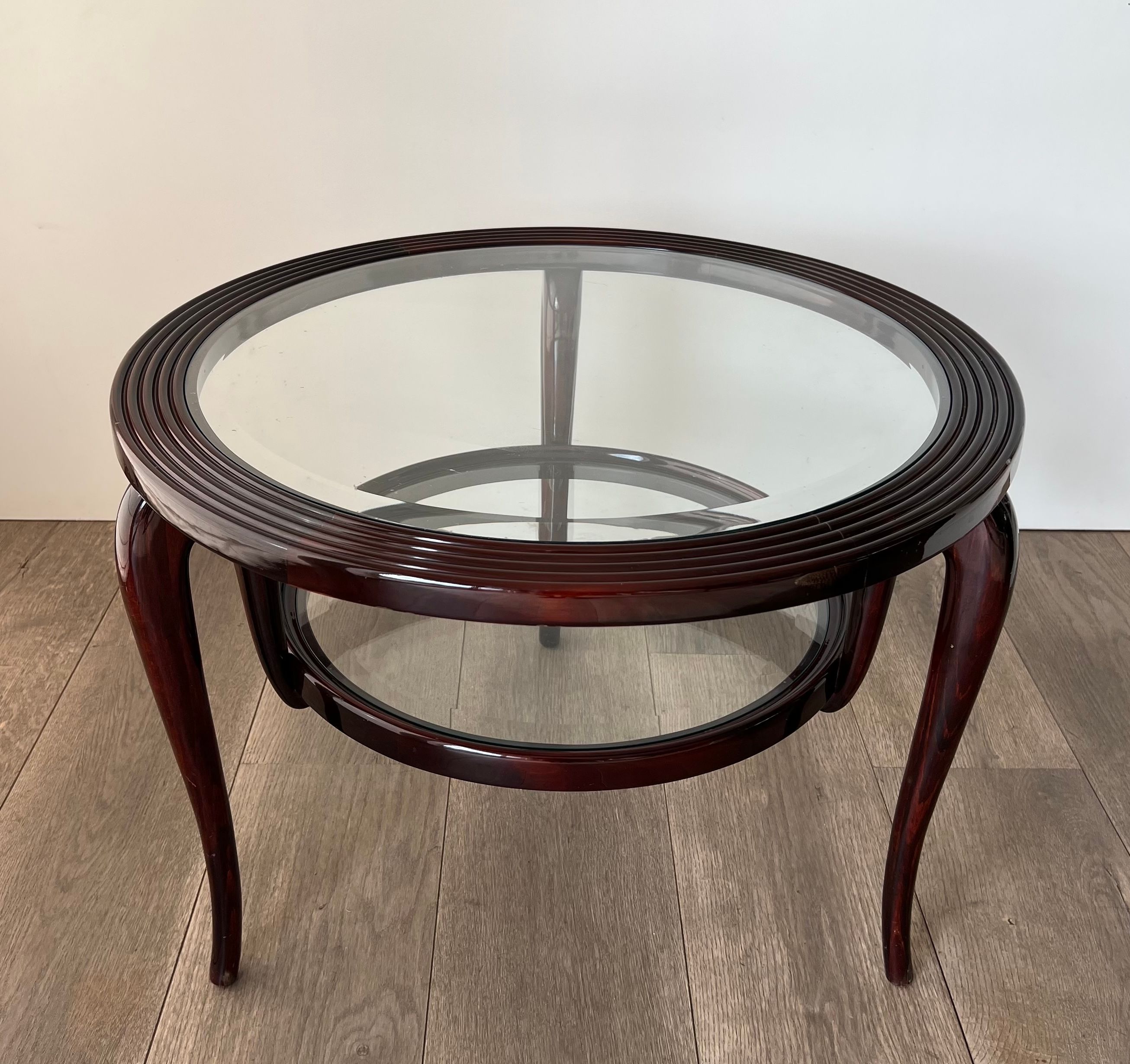Round mid-century coffee table in walnut with a double top by Paolo Buffa.