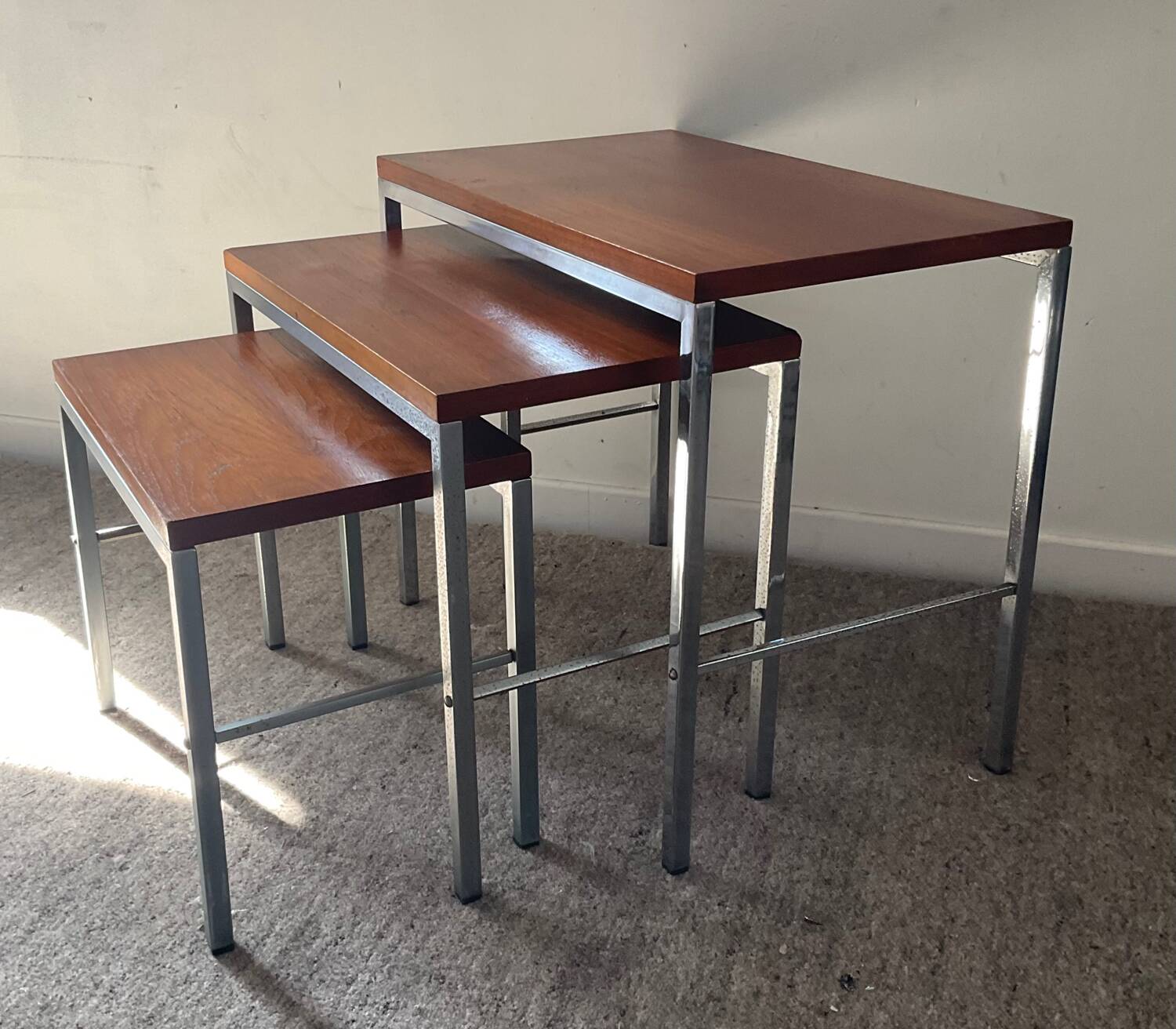 Trio of teak and chrome metal nesting tables from the 60s-70s