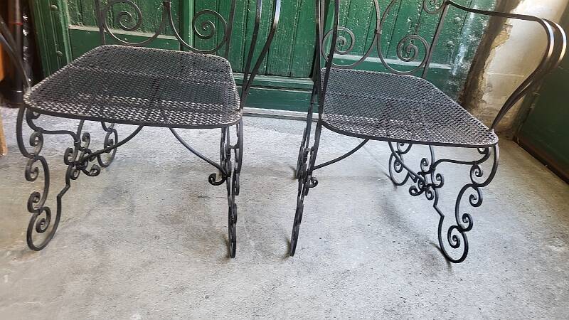 Pair of black wrought iron armchairs