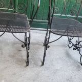 Pair of black wrought iron armchairs