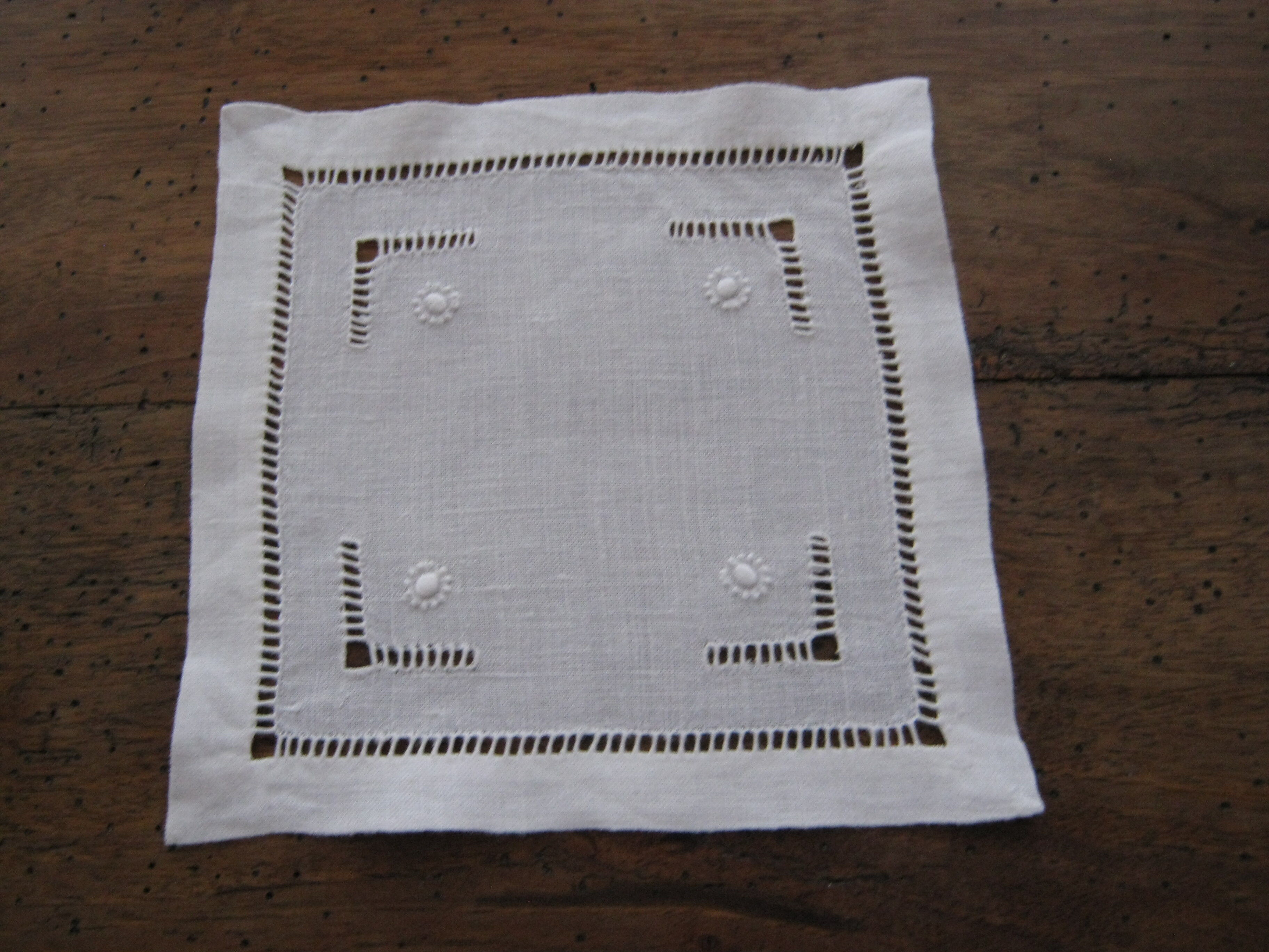 Under glass / small hand embroidered white cotton doilies