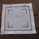 Under glass / small hand embroidered white cotton doilies
