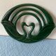 Enamelled cast iron trivet with sign decoration.