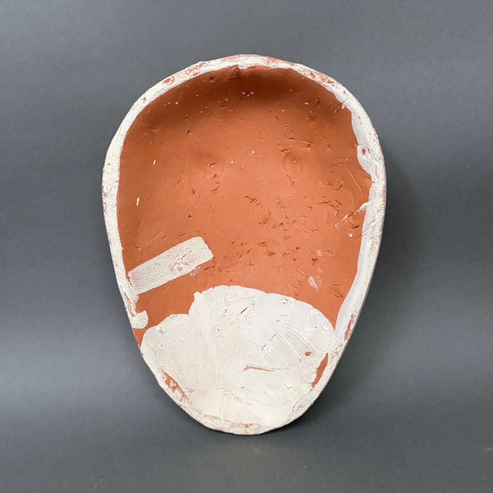 Africanist mask in glazed white terracotta, face signed Colette.