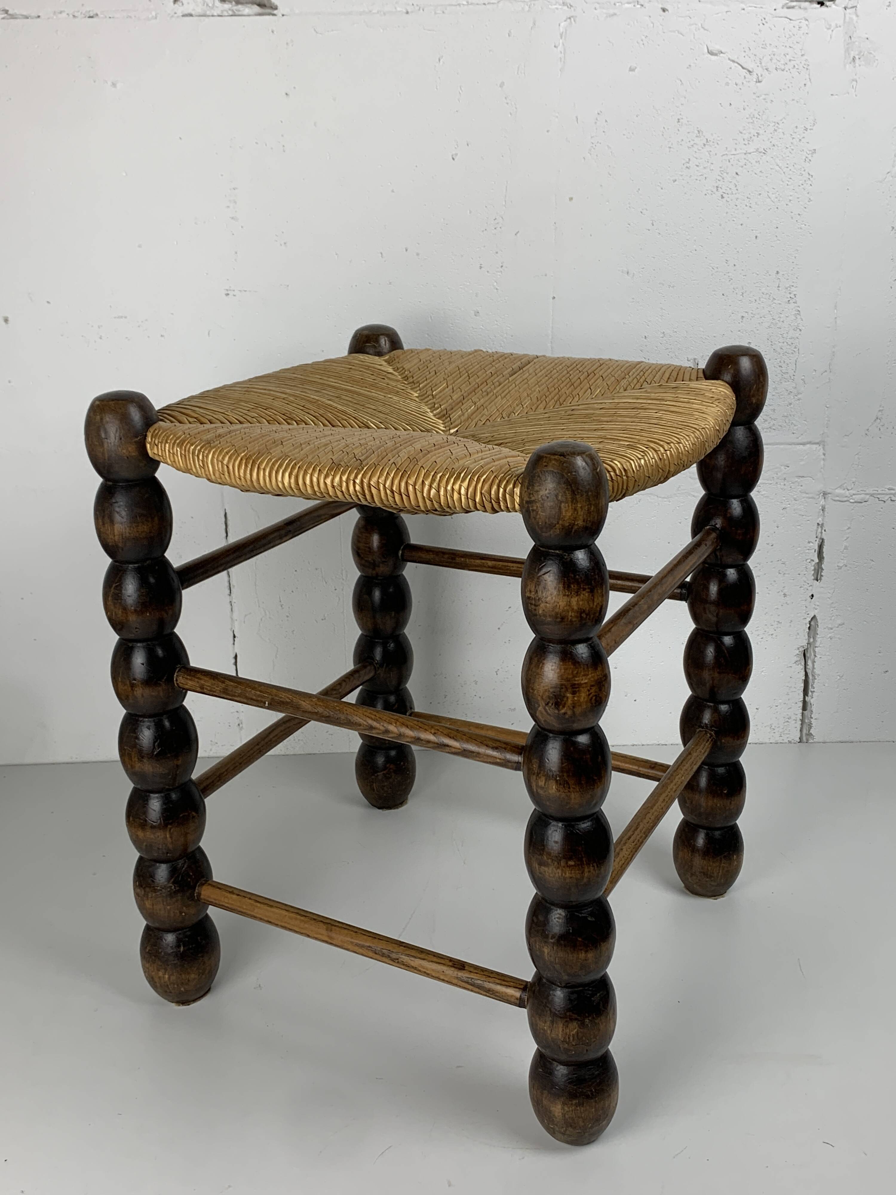 Brutalist wood turned bobbin rush stool in the style of Charles Dudouyt