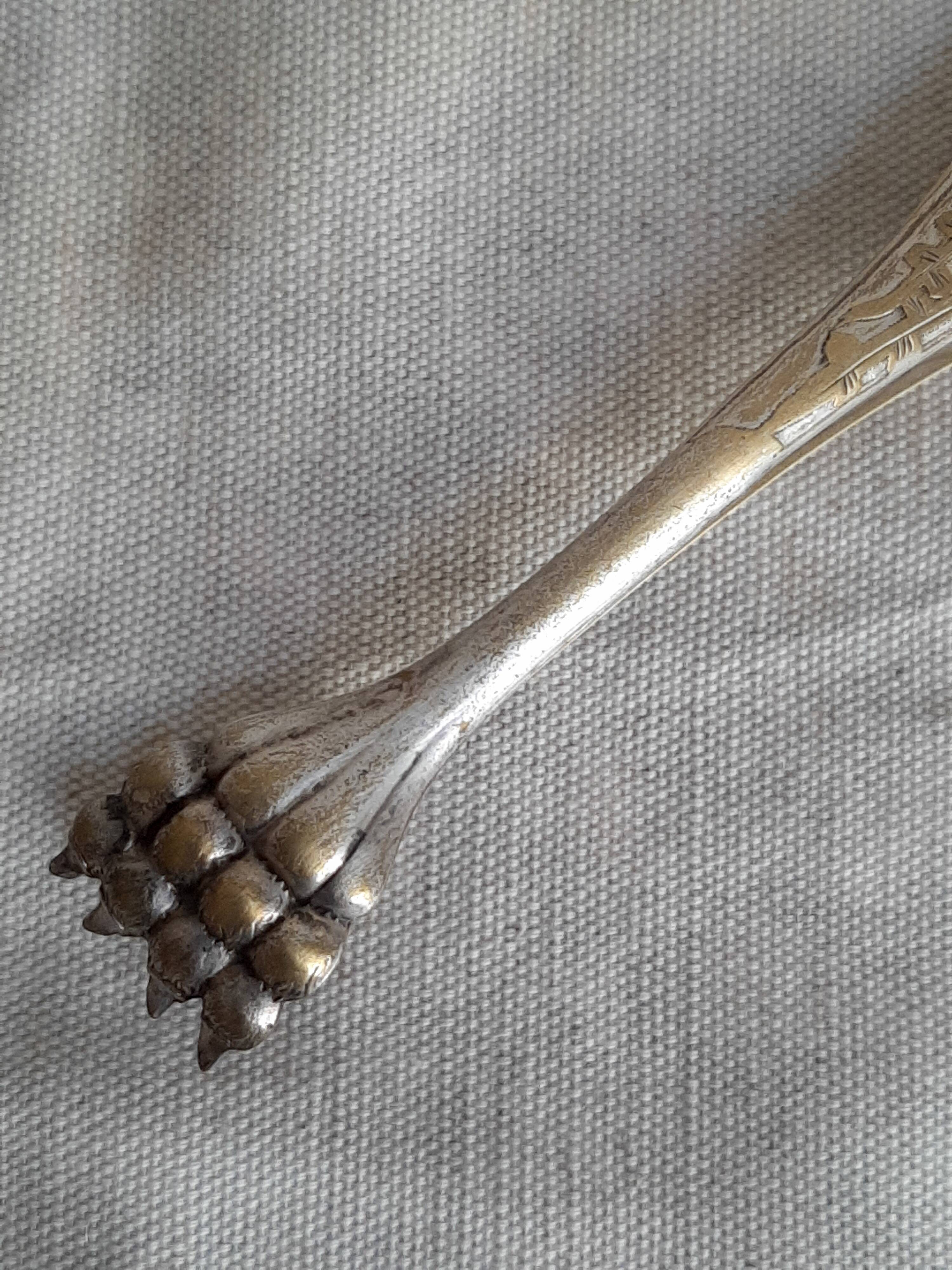 Antique silver-plated sugar tongs with lion's paws.