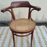 Caned chair with armrests attributed to Fischel