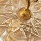 Footed catch-all / ashtray with cherub (glass and gilded metal)