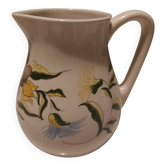 Earthenware pitcher with floral motifs in the Moustiers style, signed.
