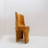 Brutalist sculptural chair in solid oak in wabi-sabi style.
