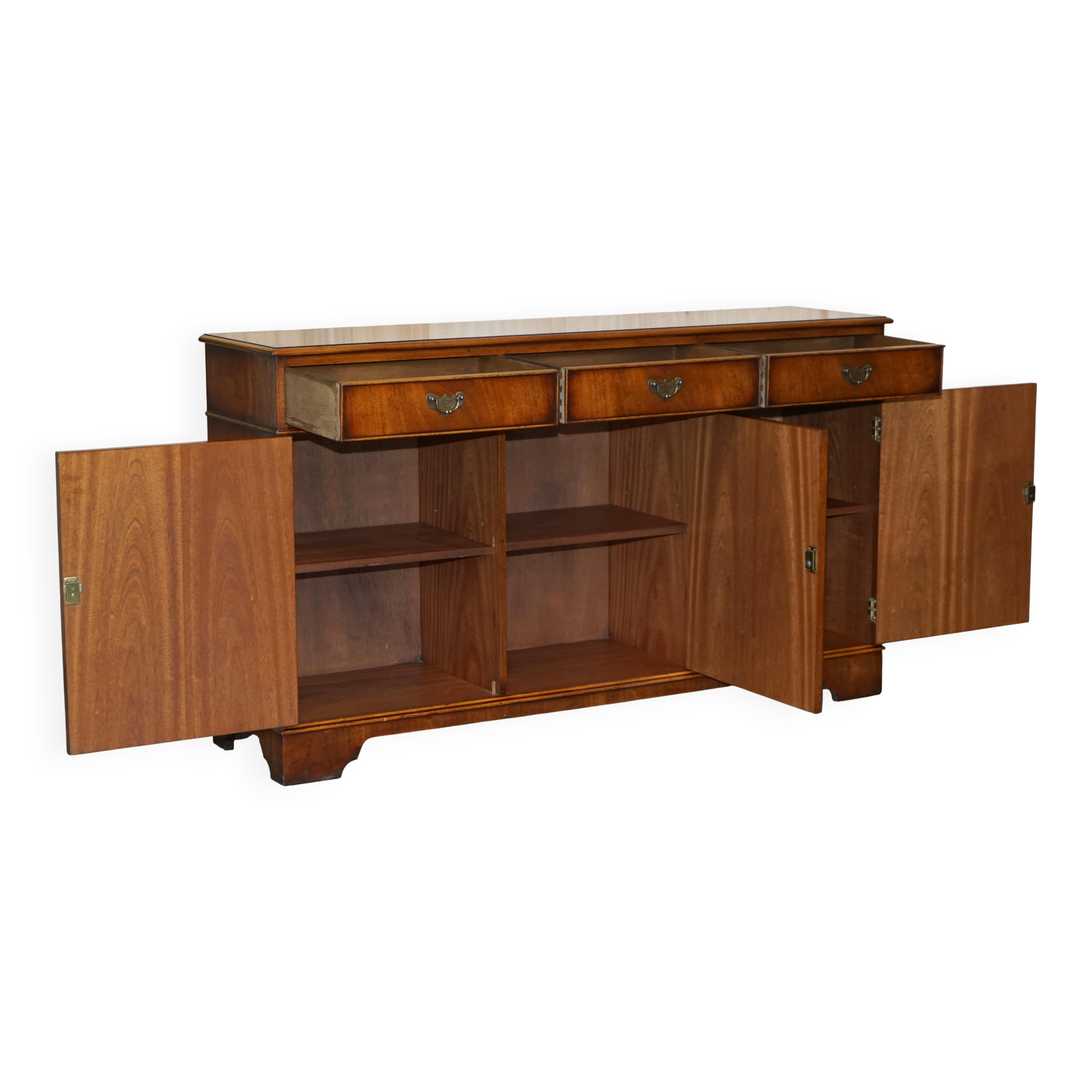 Vintage mahogany buffet with three drawers and shelves.