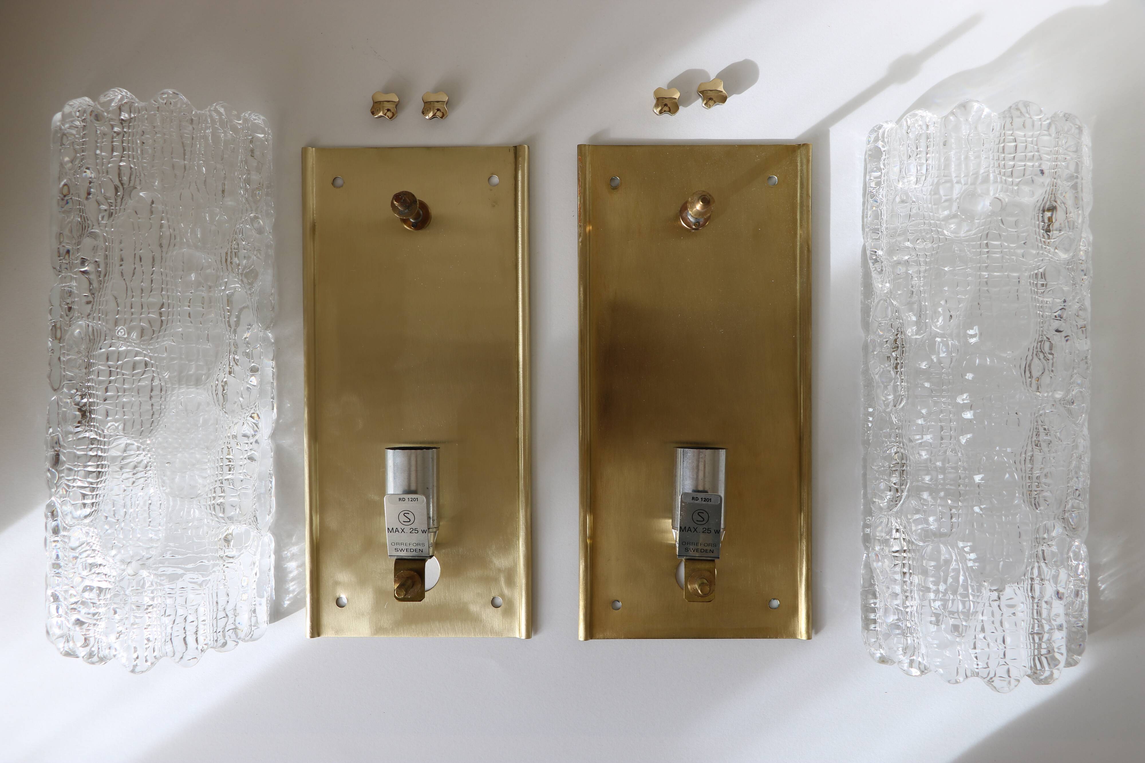 Pair of glass and brass wall lights by Carl Fagerlund for Orrefors, 1960.