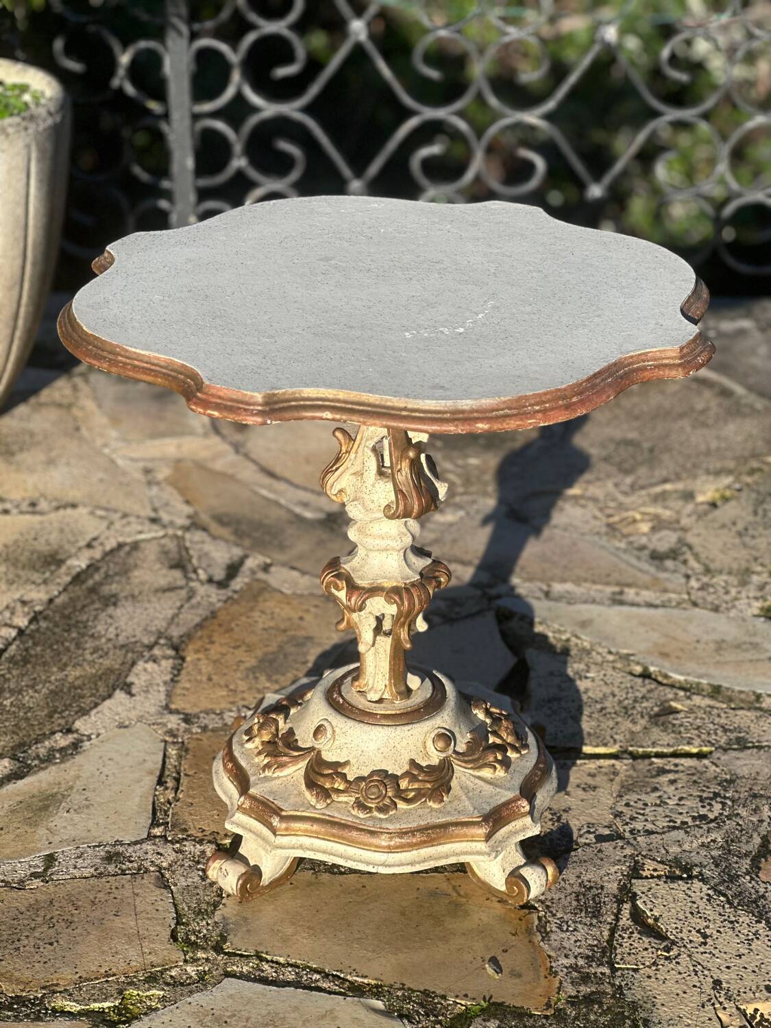 Carved and lacquered wooden side table.