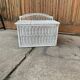 Vintage white wicker chest with double lid and decorative weaving.