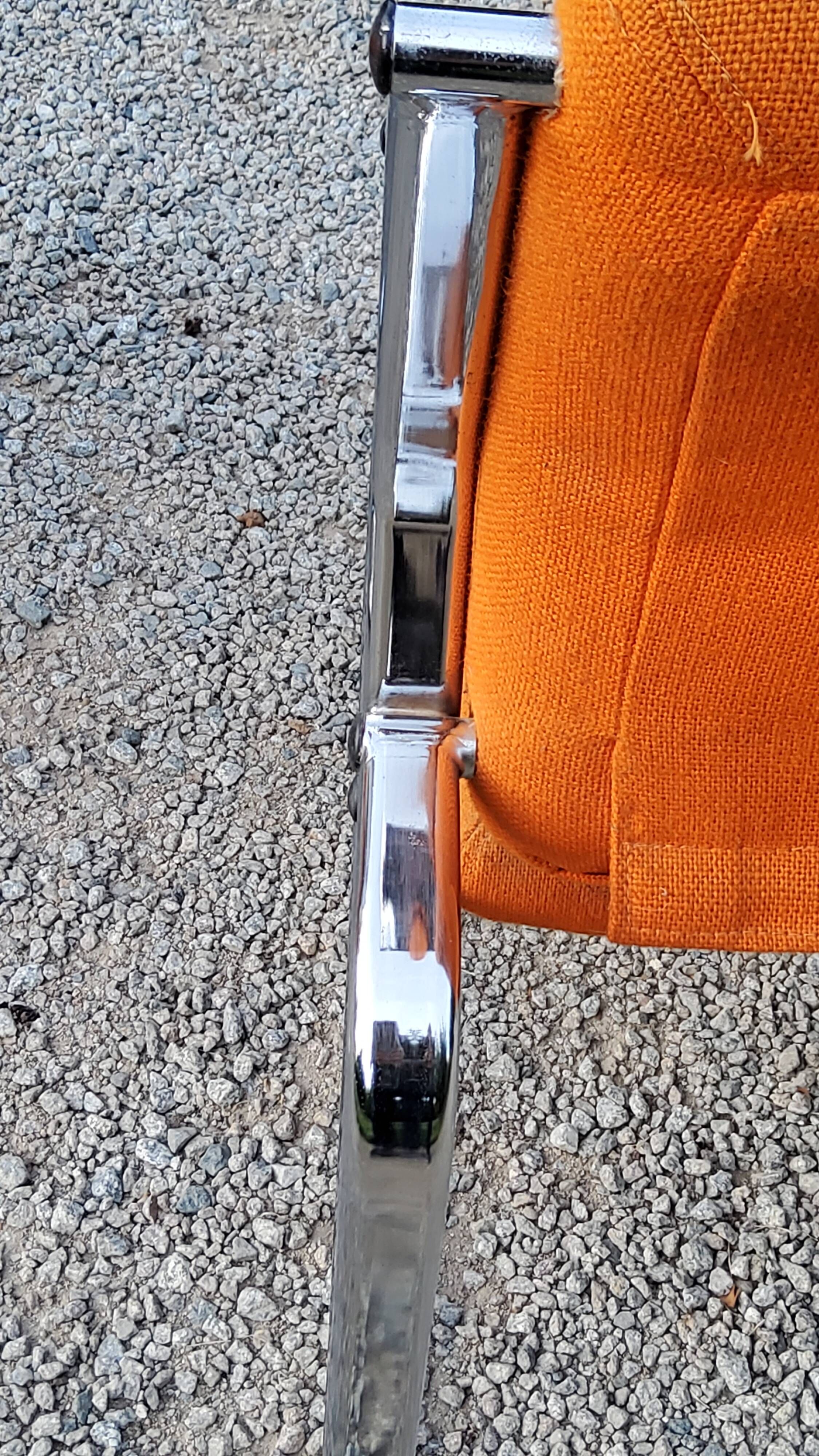 Pair of designer armchairs in orange fabrics and chrome tubes from the 70s