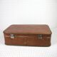 Cardboard and brown leather case