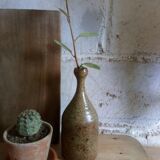 Bottled sandstone vase with a narrow neck