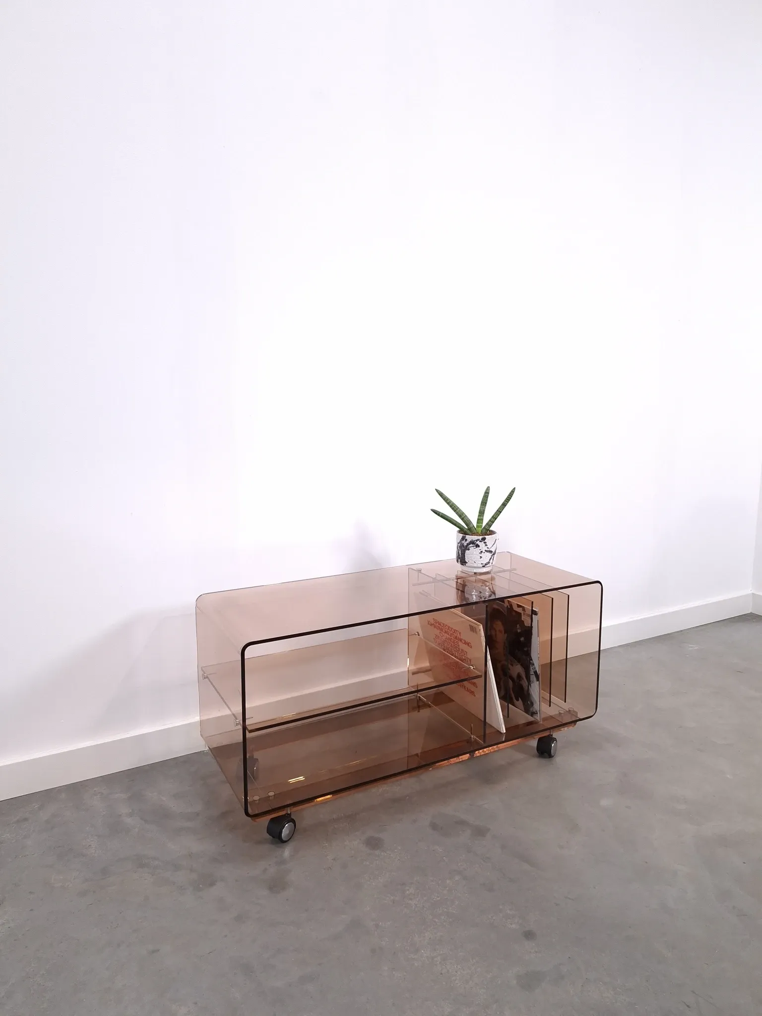 Vintage hifi, LP cabinet, TV unit made of tinted plexiglass on wheels, records.