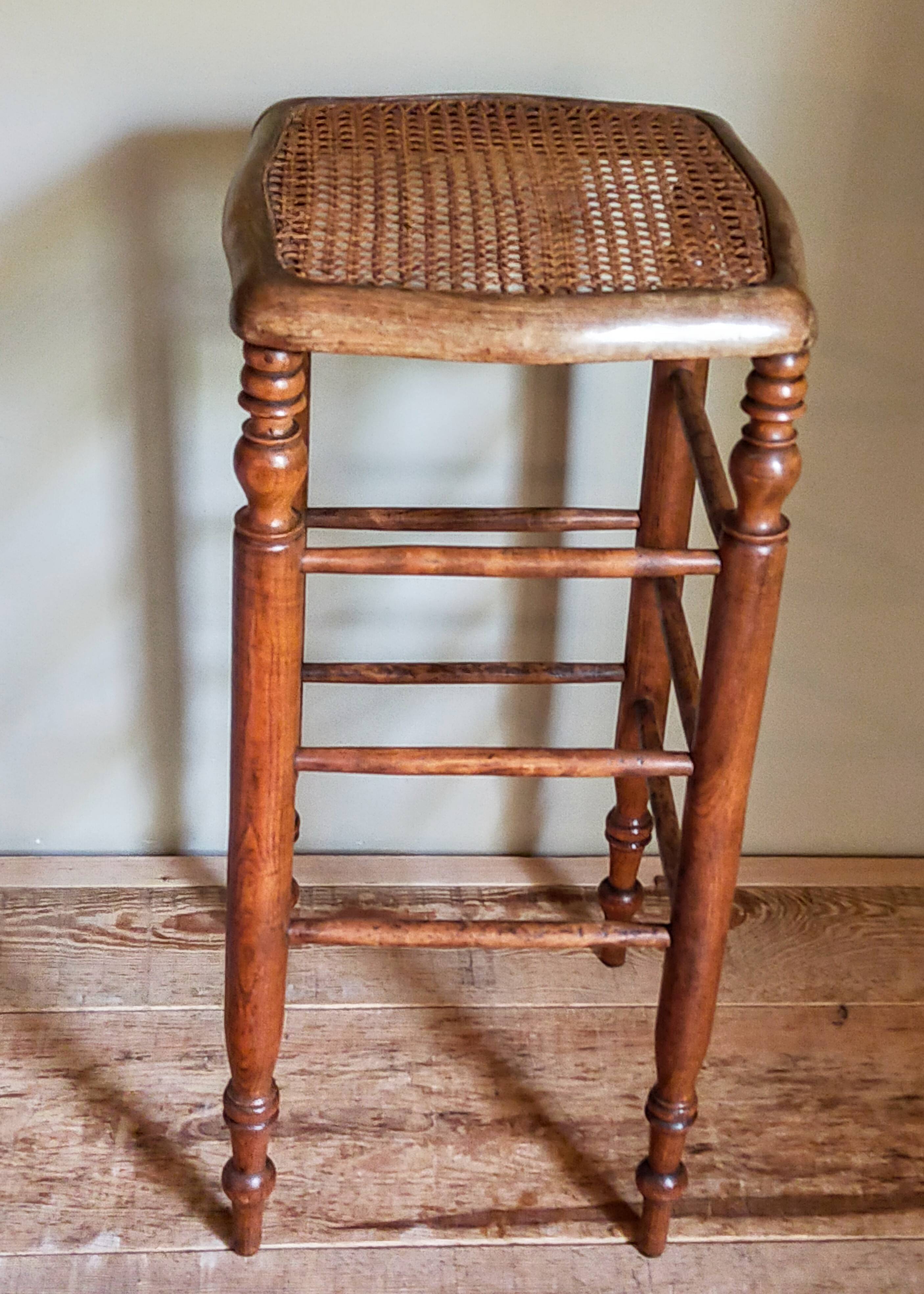 Antique stool with cane and turned wood