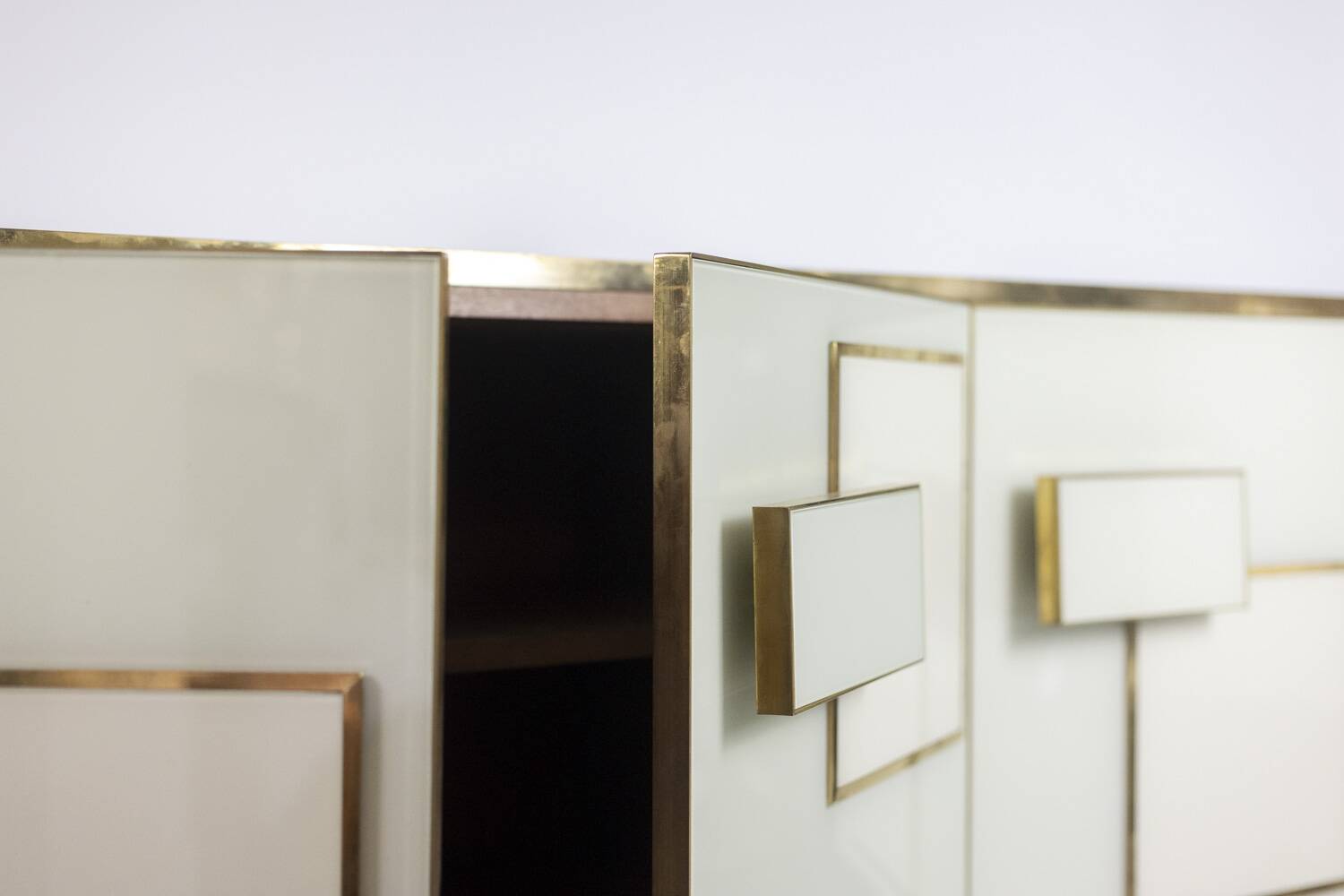 Geometric sideboard in glass and gilded brass. Contemporary Italian work.