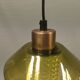 Hanging lamp with an outer shade of olive green glass and an inner shade of clear, crystal glass.