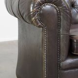 Old dark brown 3-seater cowhide chesterfield sofa with lots of character