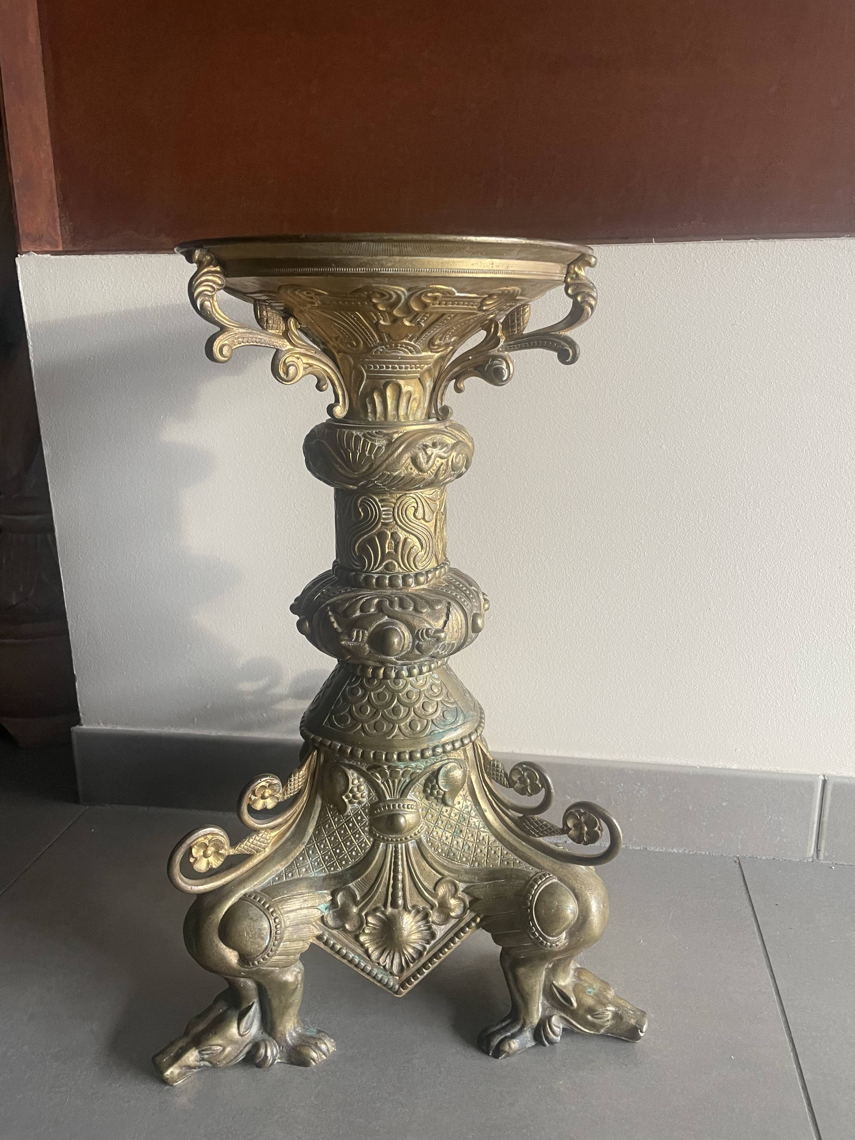 Large bronze candlestick with tripod and winged dog decoration, 19th century.