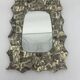 Free-form mirror decorated with cherubs.