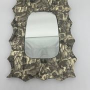 Free-form mirror decorated with cherubs.