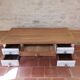 Solid wood desk with distressed white paint.