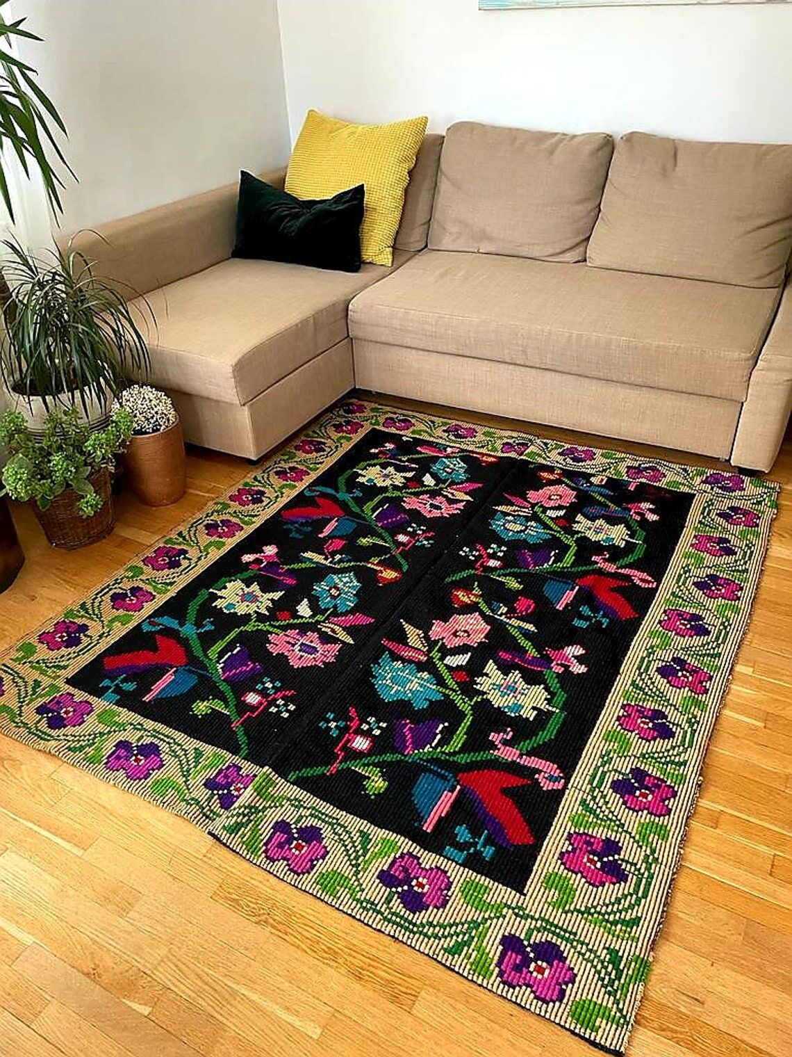 Romanian wool carpet floral design with green border on black background 180x153cm