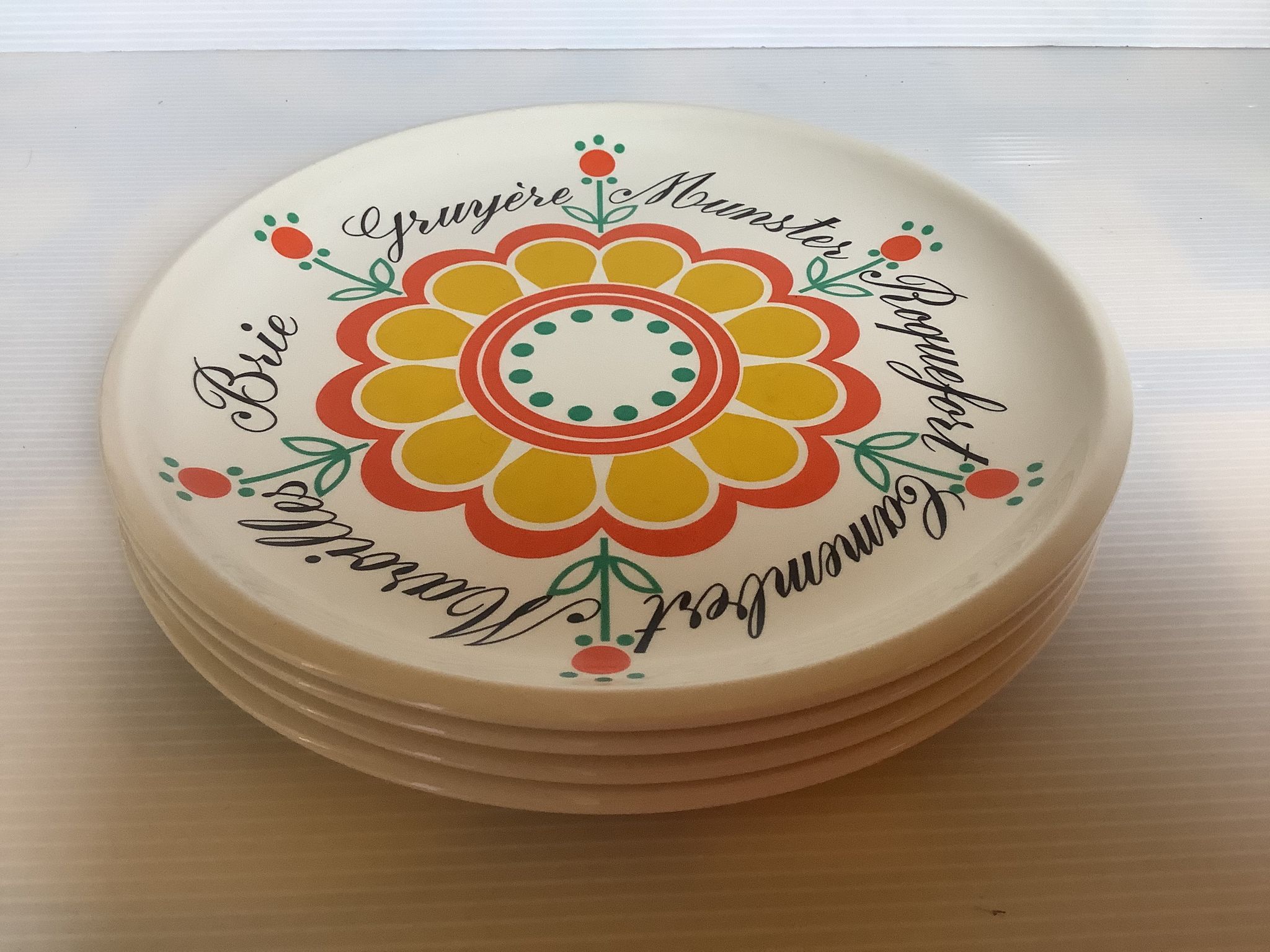 Four vintage floral cheese plates.