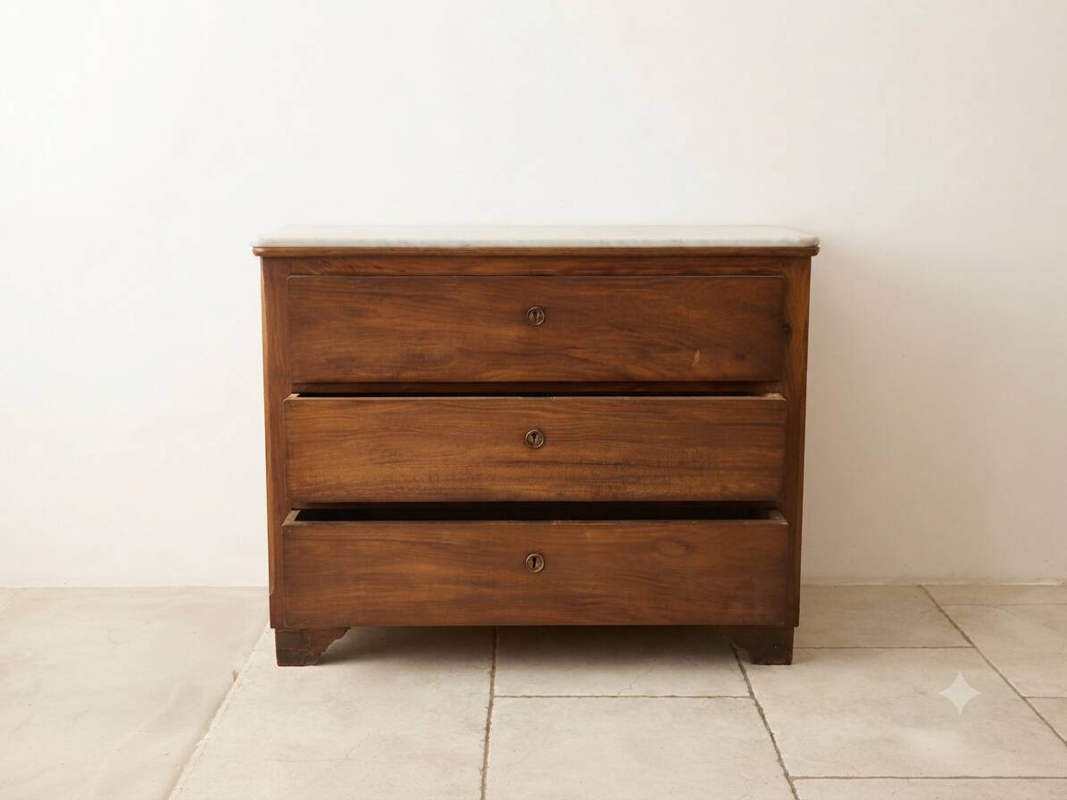 Antique solid wood chest of drawers with a white marble top.