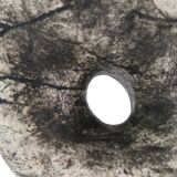 Ceramic vase sculpture decorated with faces and featuring a hole, 1980s.