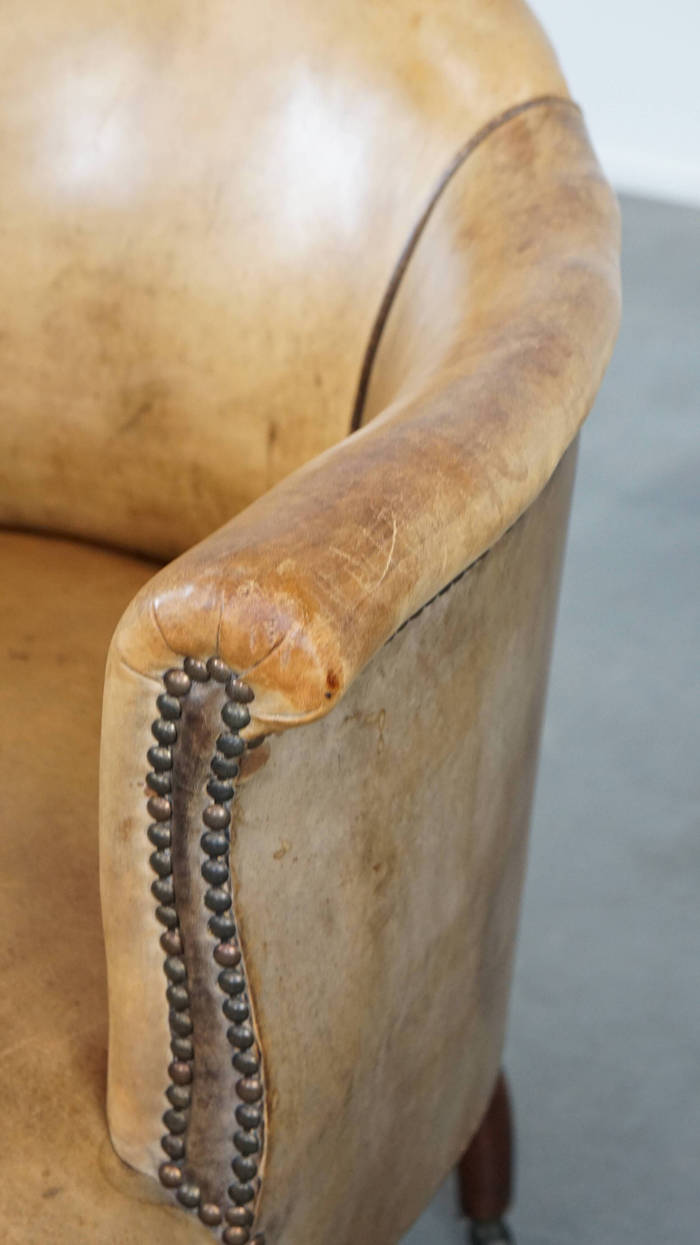 Antique sheep leather club chair/armchair on wheels
