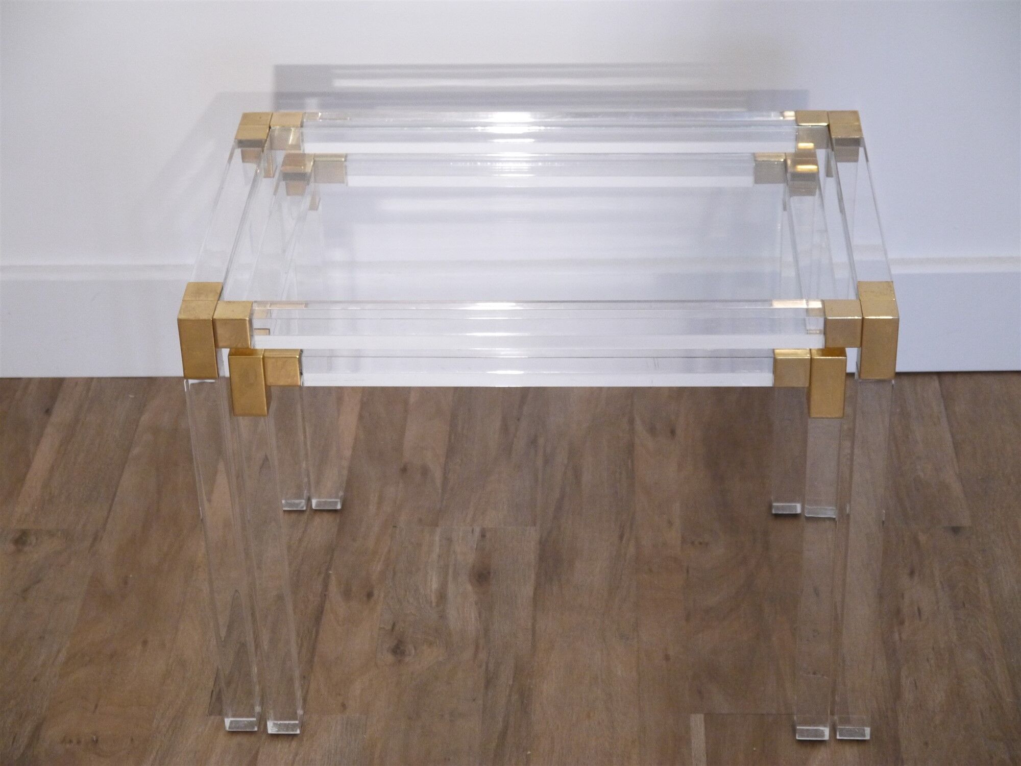 Nesting tables from the 1970s in brass, glass and lucite