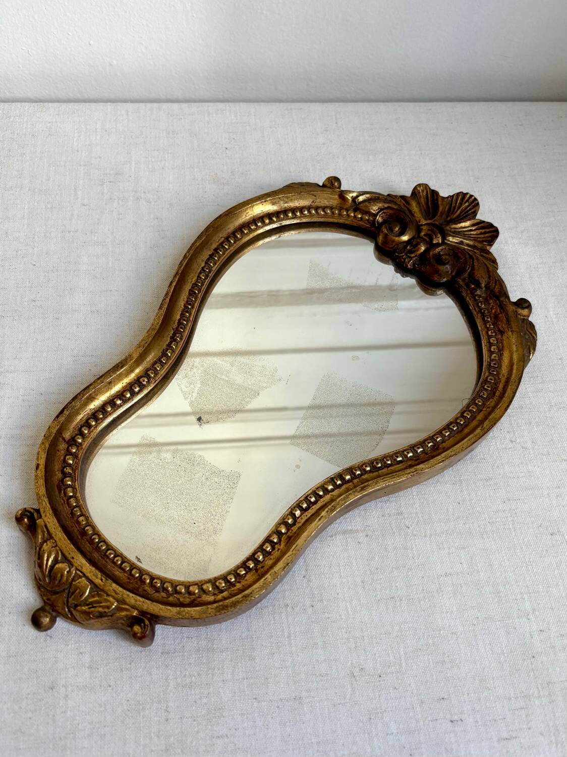 Small golden mirror in baroque style