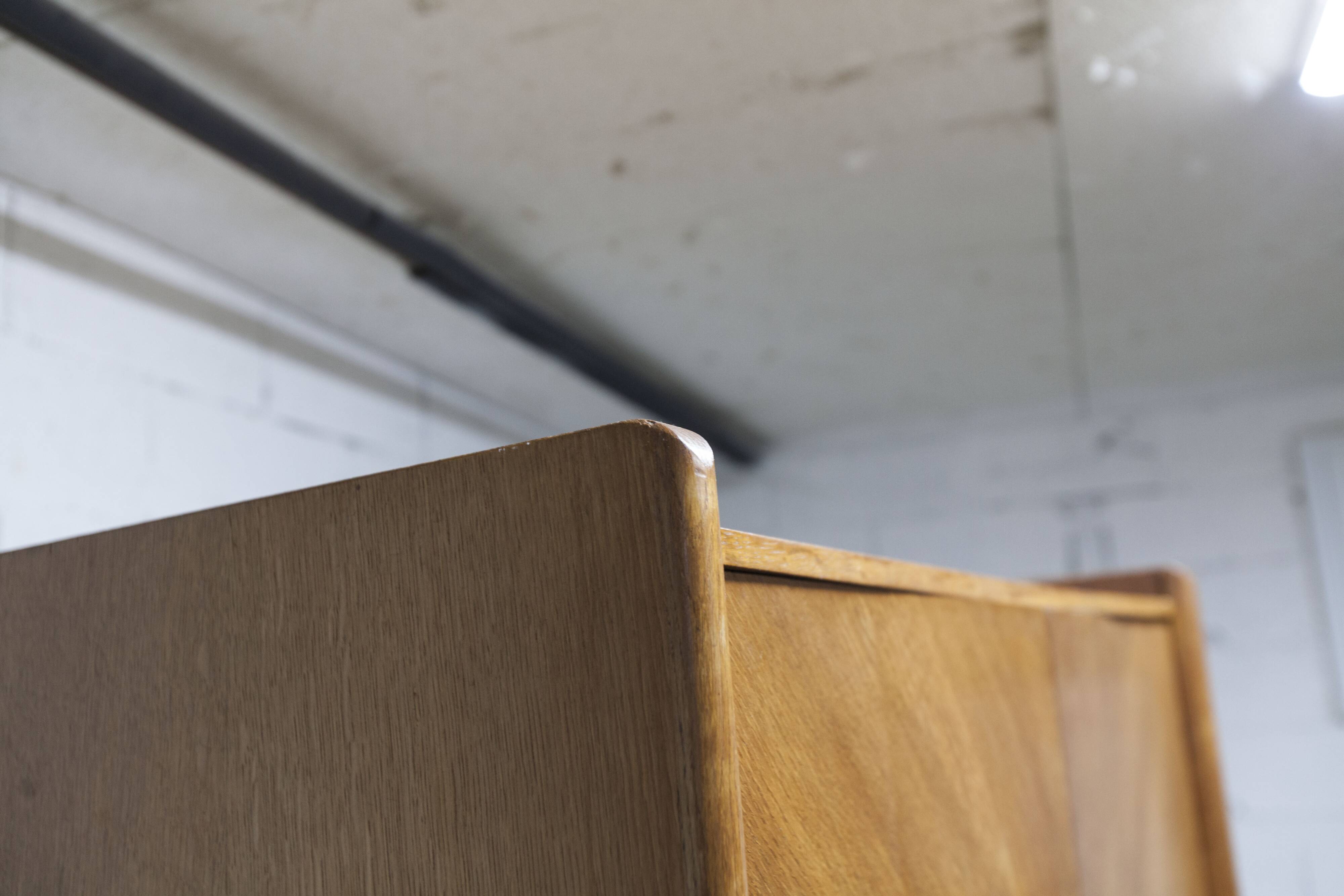 1950s Mid-Century Modern oak armoire with two doors and two drawers.