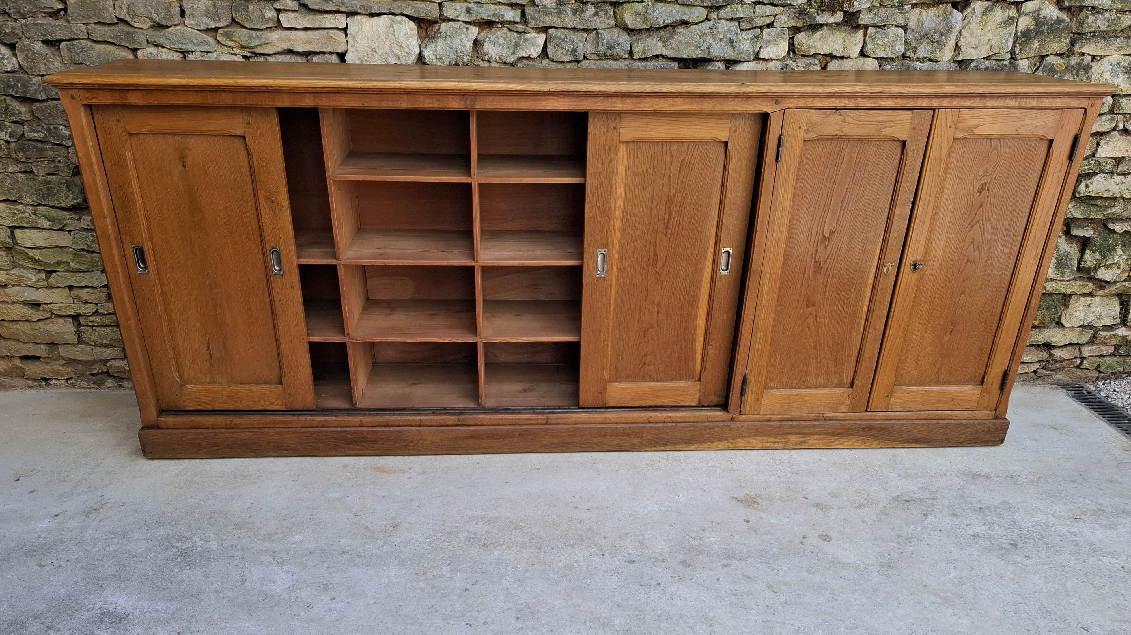 Oak workshop furniture with sliding doors.