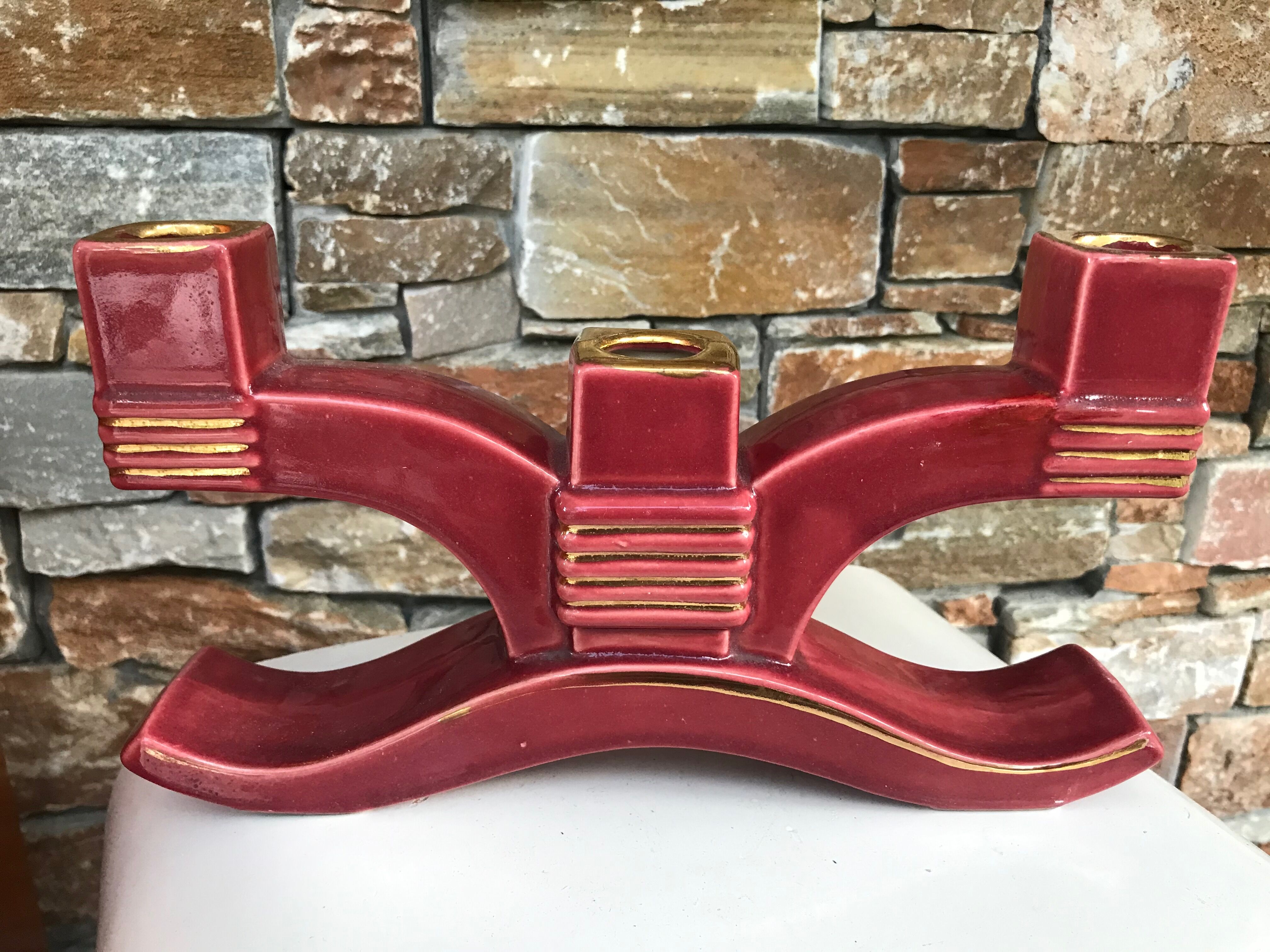 Former pair of burgundy ceramic candlesticks