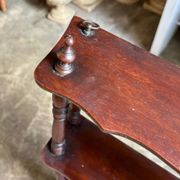 Curved and turned wooden wall shelf