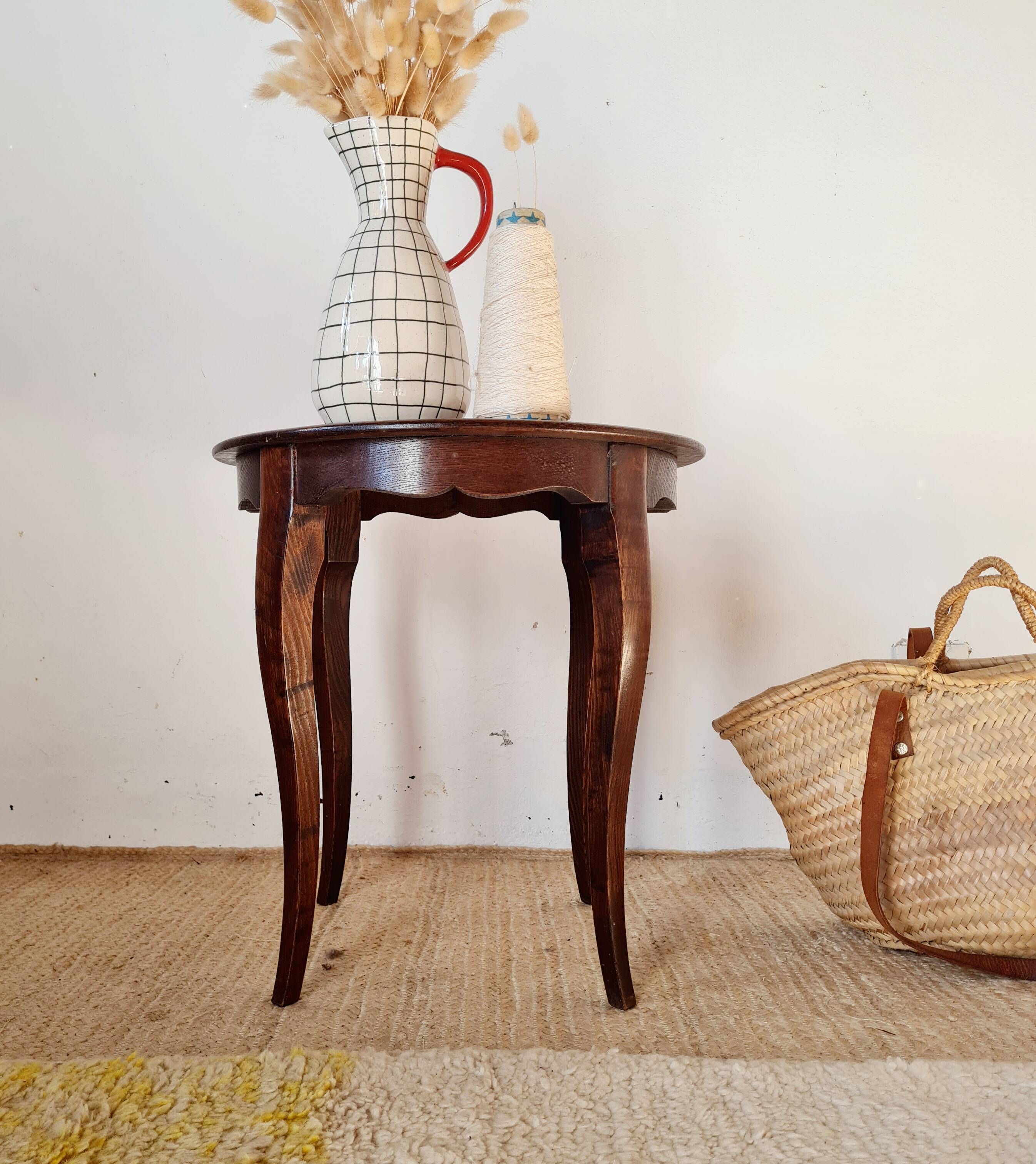 Vintage solid wood side table with curved legs.