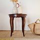 Vintage solid wood side table with curved legs.